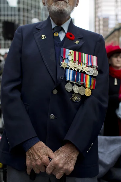 Mid section of a senior man with coat and medals — Stock Photo, Image