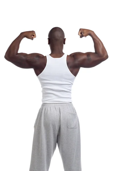 Young man flexing muscles — Stock Photo, Image