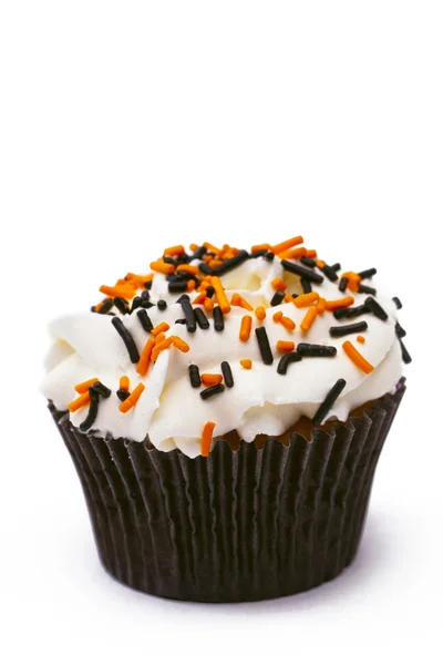 Muffin with white icing decorated with sprinkles — Stock Photo, Image