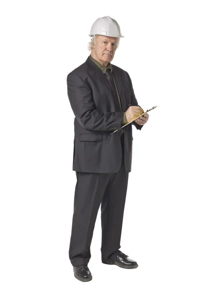 Old male engineer writing on a board — Stock Photo, Image