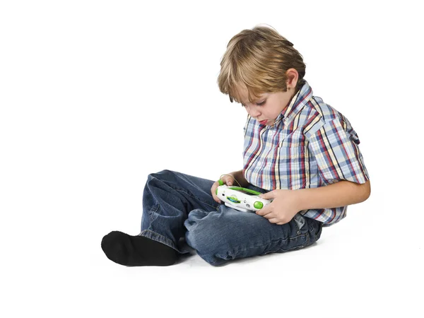 Elementary boy playing video game — Stock Photo, Image