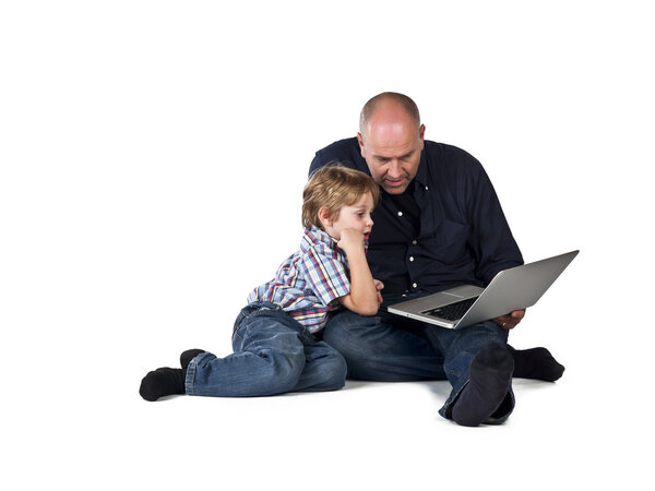 father and son using laptop together