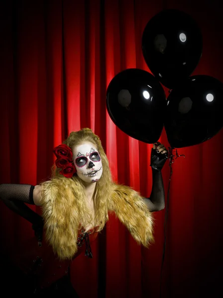 Female wearing traditional sugar skull posing with balloons — Stock Photo, Image