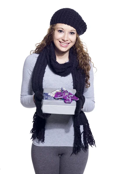 Portrait of a young woman with her christmas present smiling — Stock Photo, Image