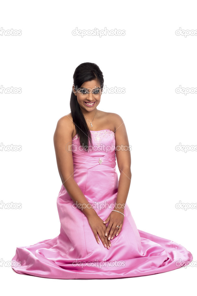 Portrait of a young woman kneeling down and smiling Stock Photo by