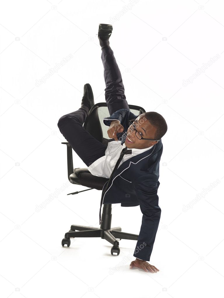 portrait view of a smiling businessman leaning on chair