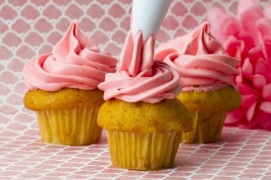 decorating cupcakes with an icing tube clipart