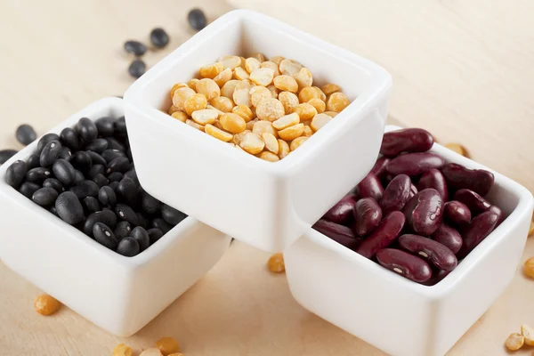 Arrangement of assorted beans on a white bowl — Stock Photo, Image