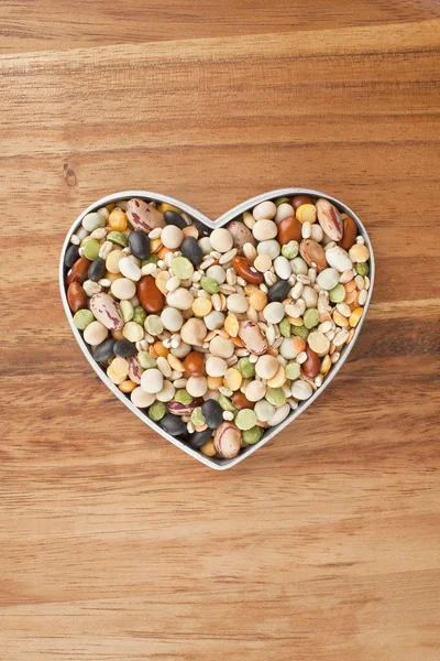 Rozmanité fazole na kontejner tvar srdce — Stock fotografie