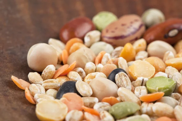 Assorted beans on a wooden table — Stock Photo, Image