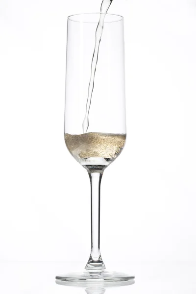 Champagne som hälls i ett tomt glas — Stockfoto