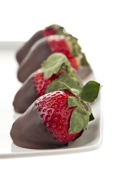 Chocolate dipped strawberries on plate — Stock Photo, Image