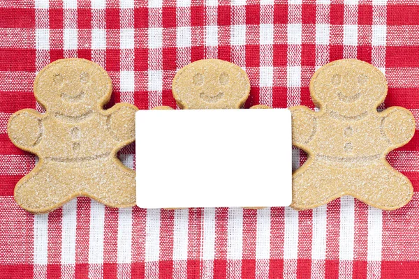 Close up tiro de gingerbread doces arranjados com cartaz em branco — Fotografia de Stock