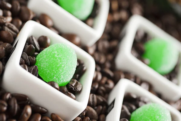 Coffee beans and green candies — Stock Photo, Image