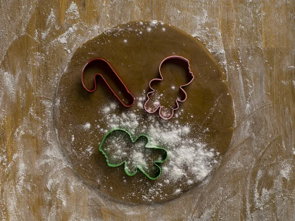 Cookie cutters on dough — Stock Photo, Image