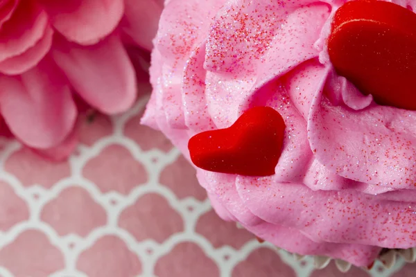 Extreme close up of strawberry cupcake with heart shapes embedde — Stock Photo, Image