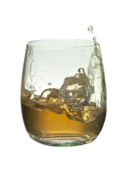Ice cube into a glass on brandy with a splash — Stock Photo, Image