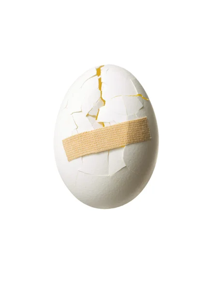 Medical bandage applied on cracked egg — Stock Photo, Image