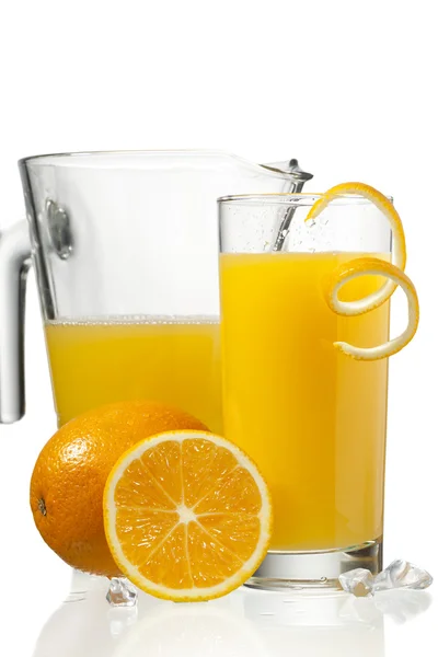 Orange juice in glass and a jar — Stock Photo, Image