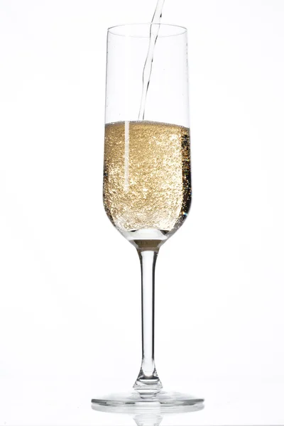 Champagne falling in champagne flute Royalty Free Stock Images