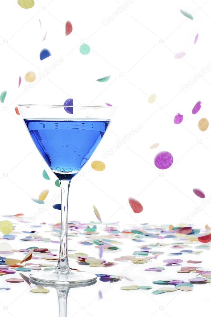 Martini glass with curacao and confetti on white