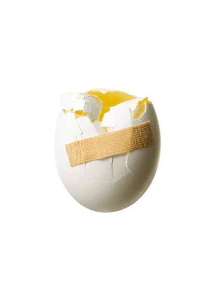 View of a broken egg with a tape on it — Stock Photo, Image