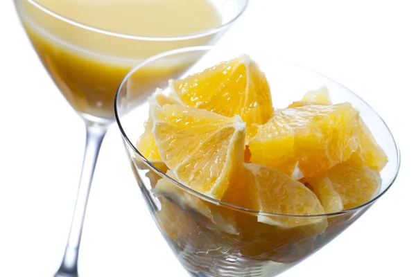 Kaksi martini lasi appelsiinimehua ja appelsiininviipale — kuvapankkivalokuva
