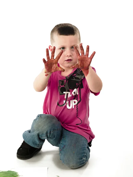 Kid shows painted hand to camera — Stock Photo, Image