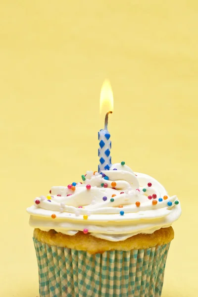 Close up shot of a cupcake with blue candle — Stock Photo, Image