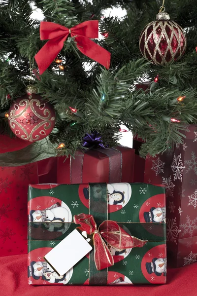 Gifts on a christmas fir tree — Stock Photo, Image