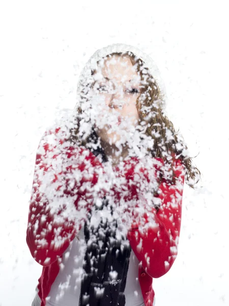 Playful young woman blowing show — Stock Photo, Image