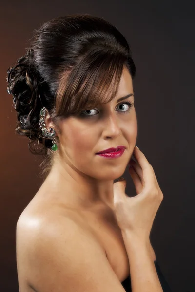 Portrait of a young female posing with hand on chin — Stock Photo, Image