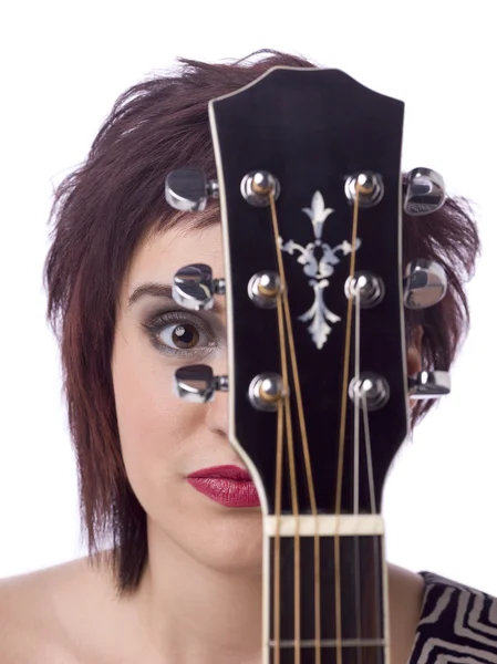 A lady musician hiding on the back of her guitar — Stock Photo, Image