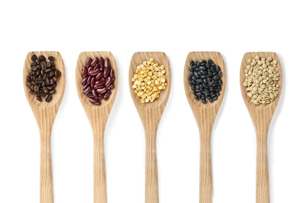 Assorted food grains on a wooden spoon — Stock Photo, Image
