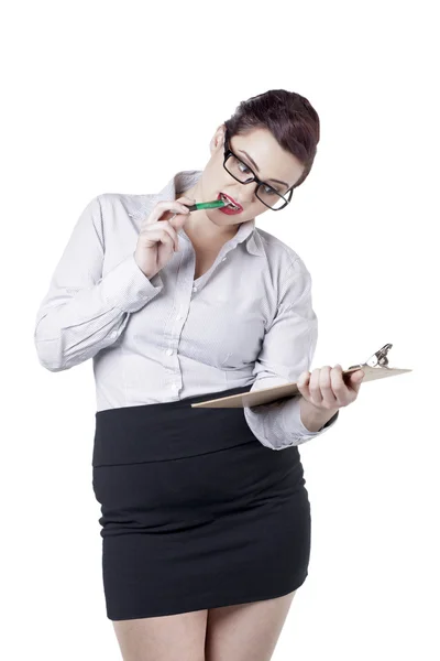 Businesswoman biting her pen — Stock Photo, Image