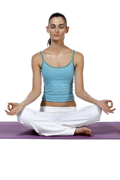 Beautiful lady meditating over the mat — Stock Photo, Image