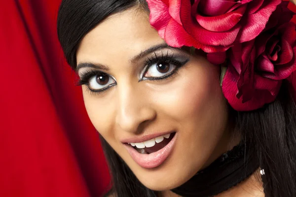 Attractive female with a rose in her head — Stock Photo, Image