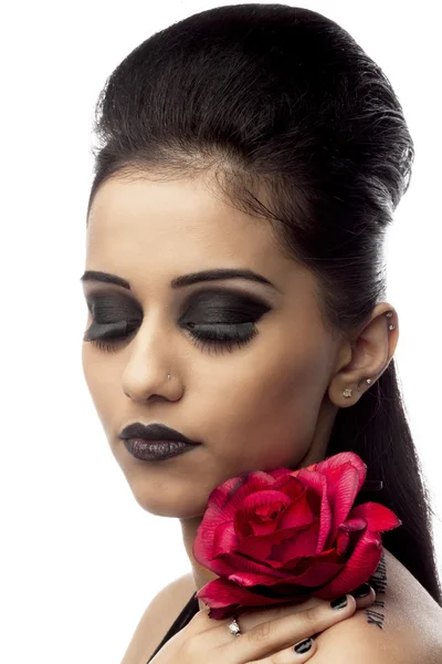 Beautiful young woman holding rose with eyes closed — Stock Photo, Image