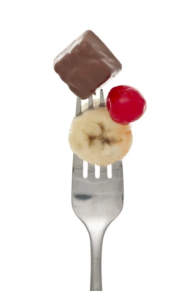Oříznout obrázek vidlice s cherry banán a čokoláda — Stock fotografie