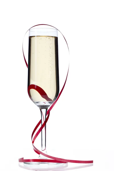 Champagne flute with red streamer — Stock Photo, Image