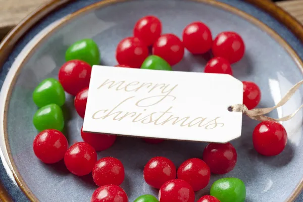 Close up image of a merry christmas tag with christmas colored c — Stock Photo, Image