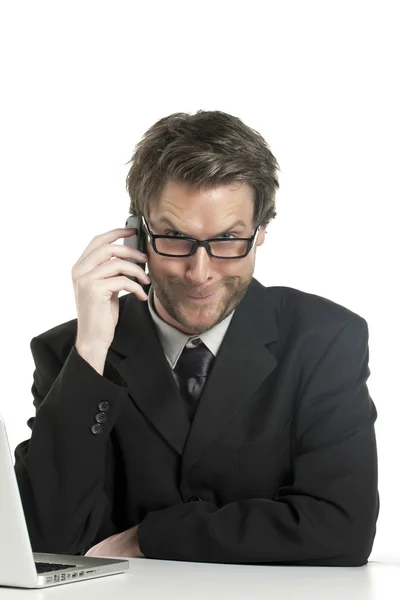 Business man making funny face while talking on the phone — стоковое фото