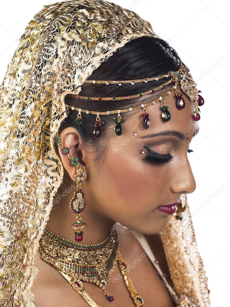 side view of a attractive female wearing bridal dress and jewelr