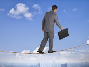 business man balancing on a rope clipart