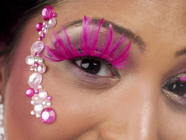 Close up of womans face with makeup and jewelry — Stock Photo, Image