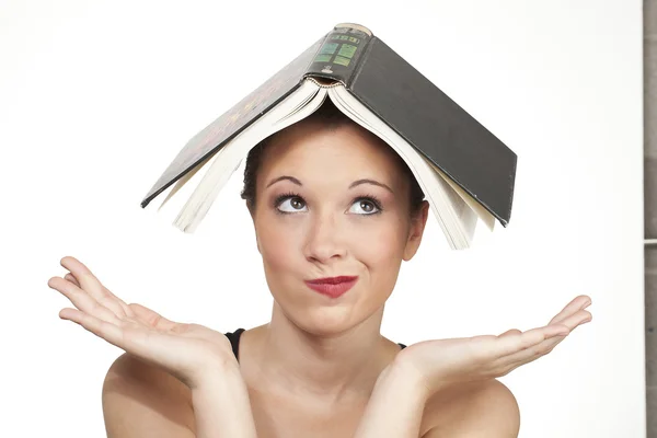 Confused expression head shot with book on head Royalty Free Stock Photos