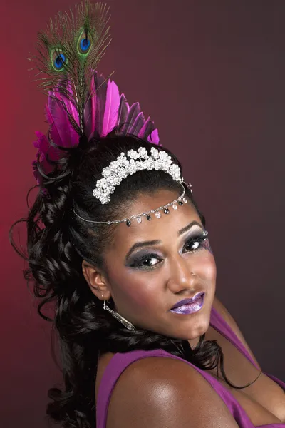 Close up shot of a young female wearing peacock feather with jew — Stock Photo, Image