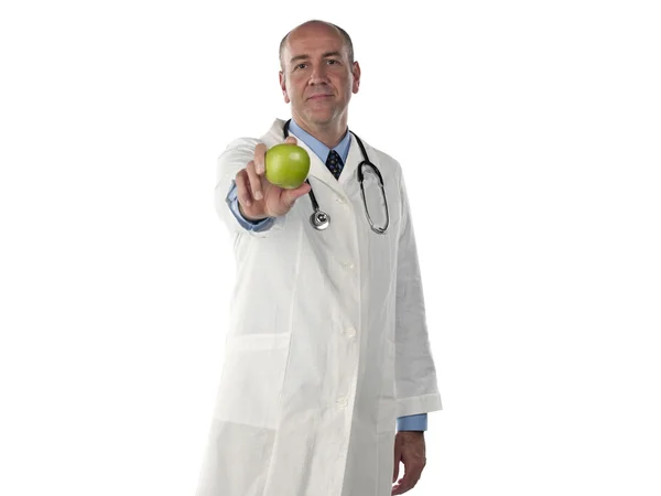 Mature doctor holding green apple — Stock Photo, Image