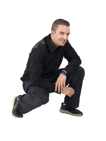 Cute guy kneeling on a white background — Stock Photo, Image