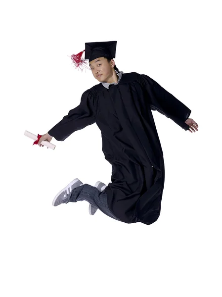 Asian guy graduate jumping — Stock Photo, Image